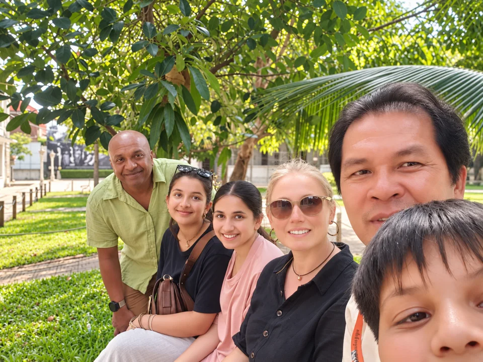 Rabbit Travel guide and guests sitting under trees